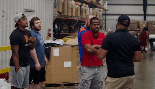 Versa Pak trainer Ryan Baer gives new hire employees a tour of the manufacturing plant.