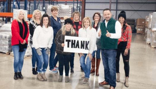 Versa Pak team members holding thank you sign while standing inside Celina, OH manufacturing plant