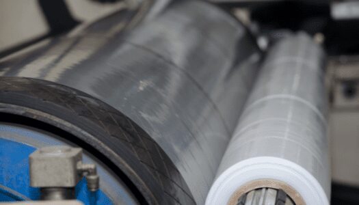 Versa Pak’s poly laminating film roll wrapping a barrel to secure it.